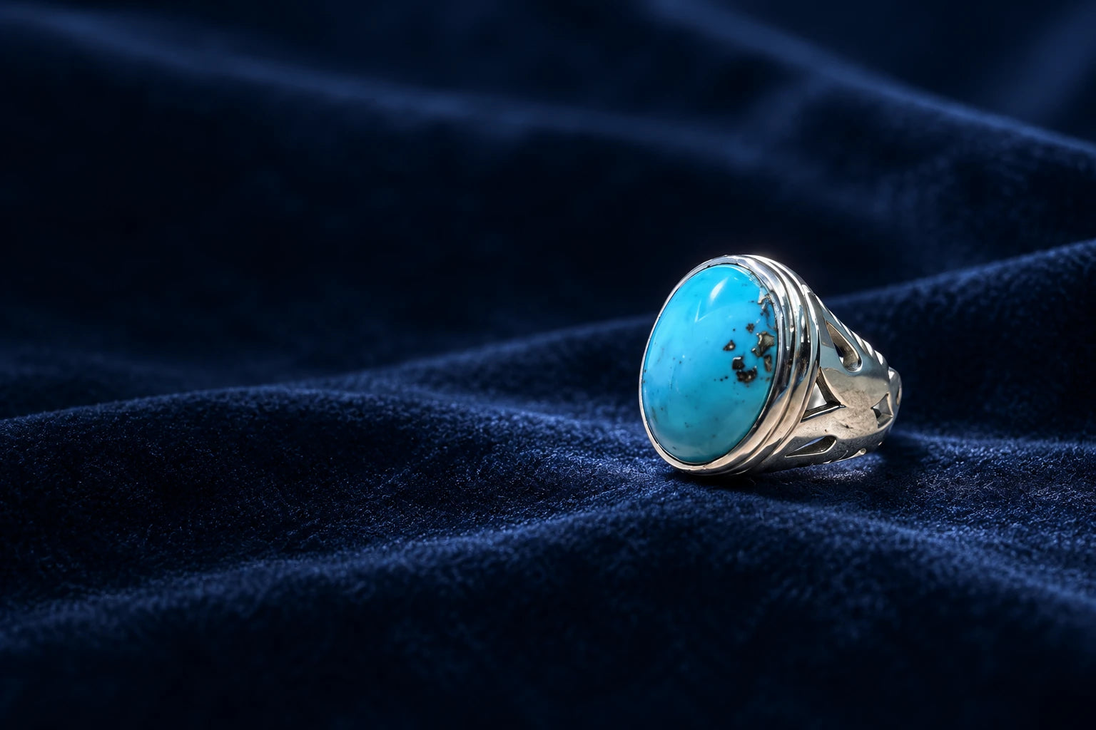 Turquoise silver ring on midnight-blue velvet